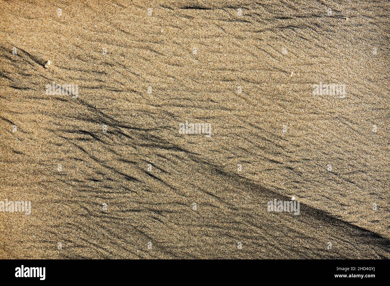 Abstract pattern made by waves on volcanic black sand of Bali island Stock Photo