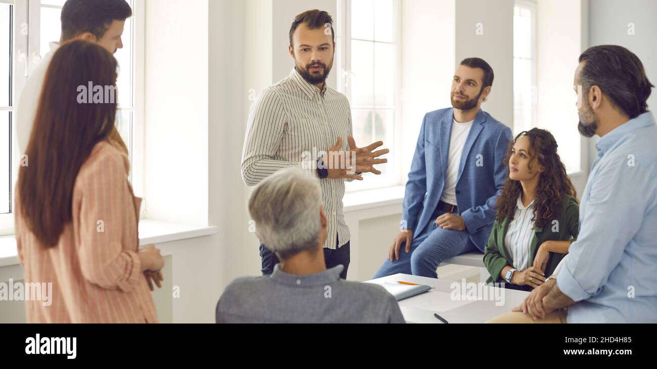 Group of people having a work meeting and listening to a team leader or corporate manager Stock Photo