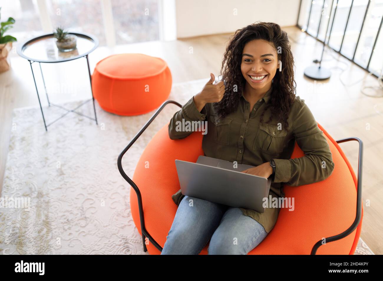 Portrait of smiling black woman using laptop showing thumbs up Stock ...