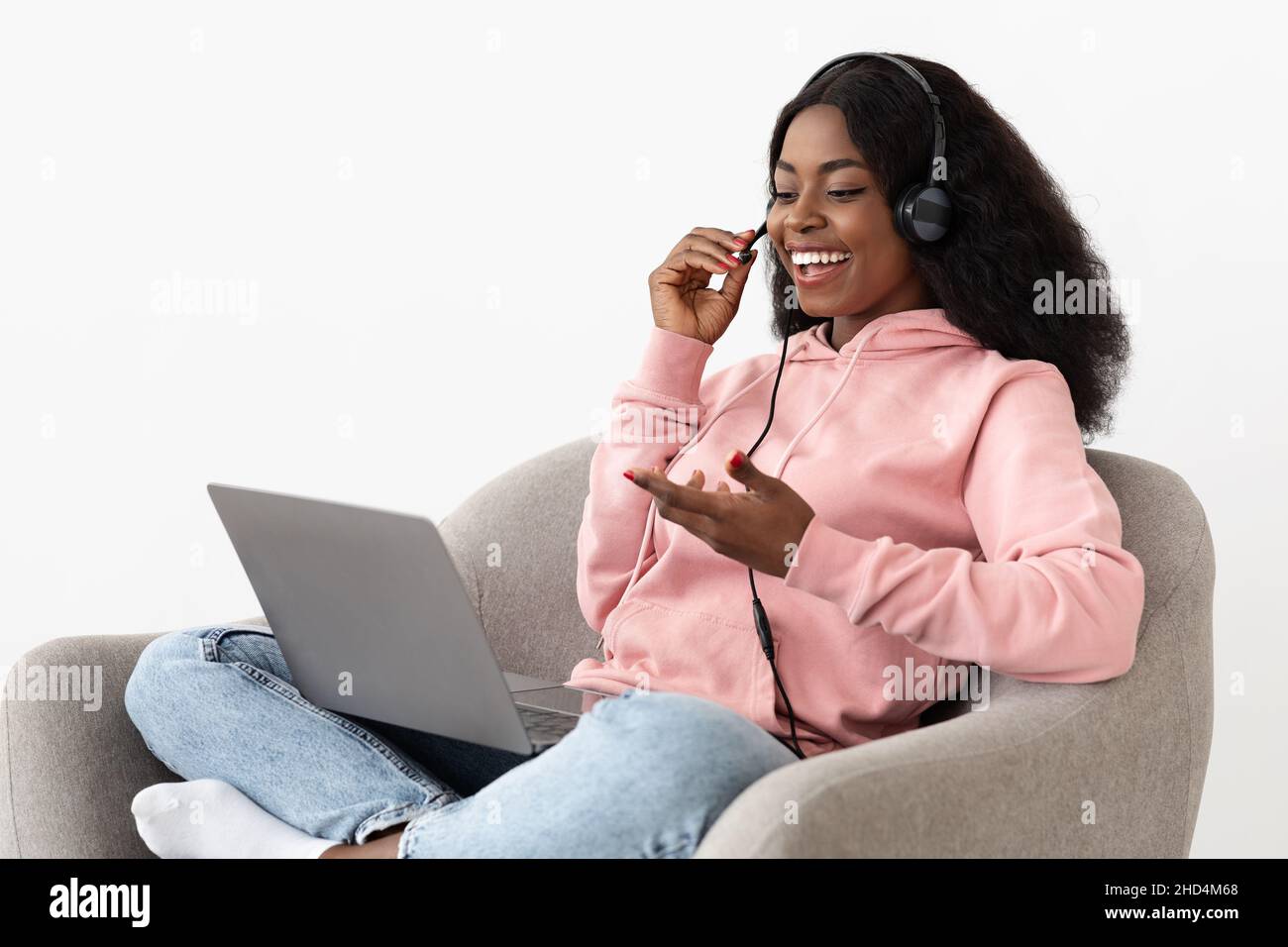 Chatty african american lady having video call, using laptop Stock Photo