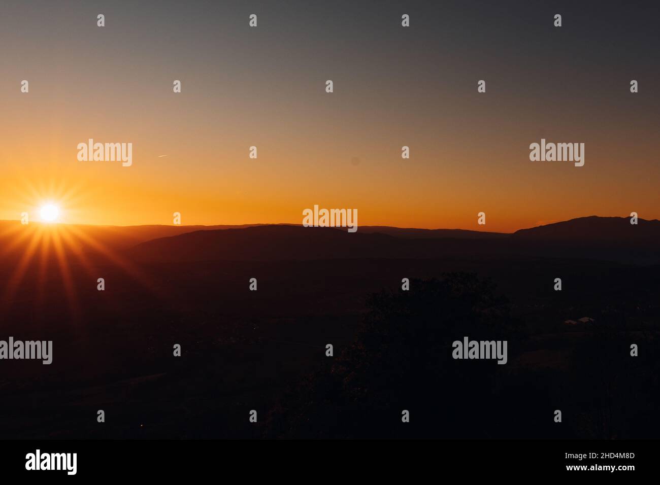 Beautiful sunset view over hilly terrain Stock Photo