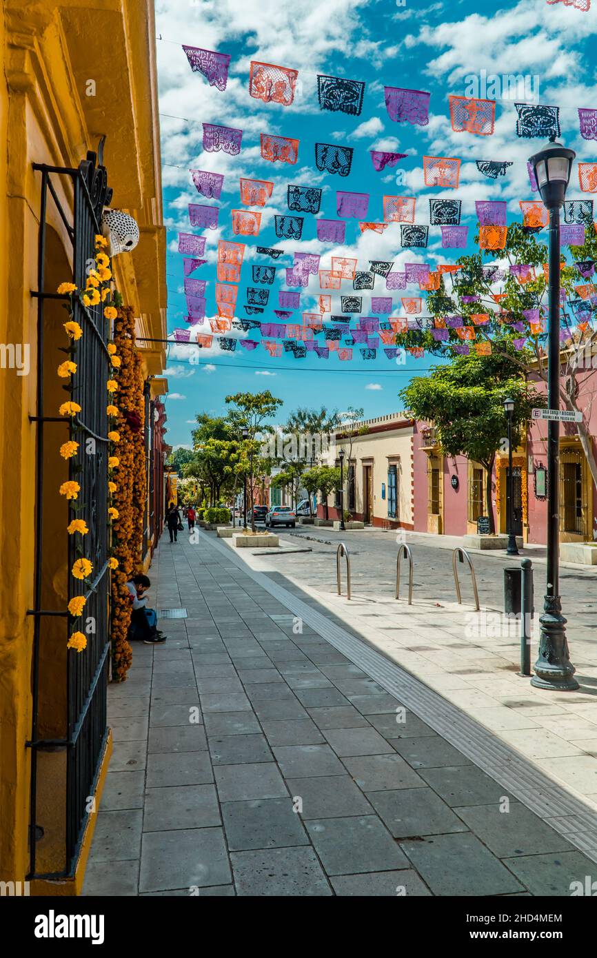 A Vertical shot of colorful colonial architecture and Day of the Dead decorations in downtown Oaxaca Stock Photo