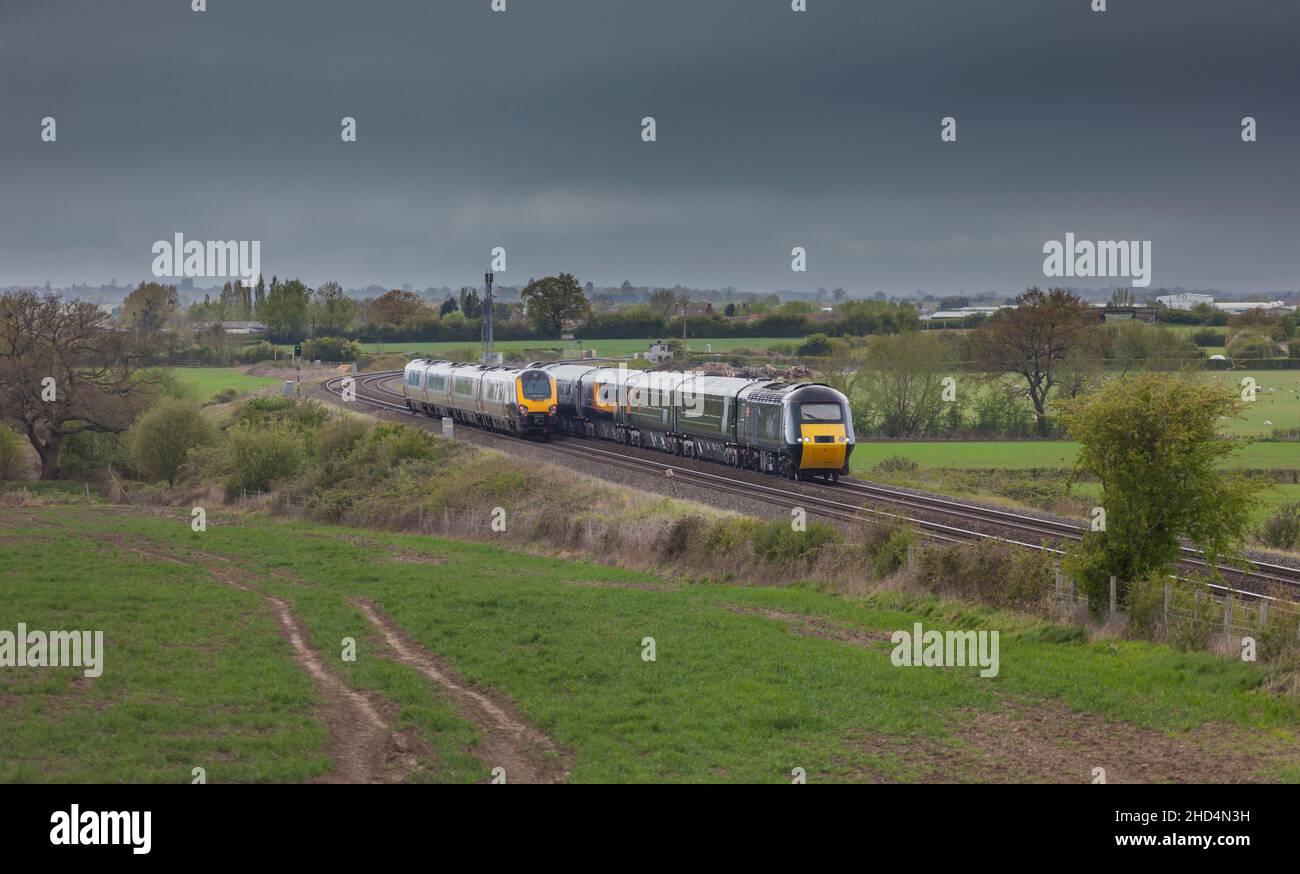 Crosscountry Trains Voyager and Great Western railway castle high speed train passing in the Gloucestershire countryside with copy space Stock Photo