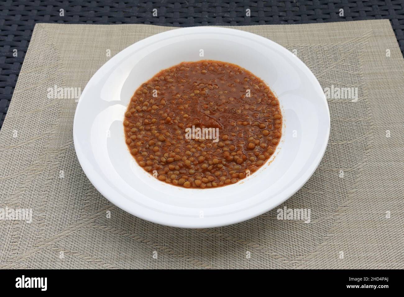 Lentil legume soup with tomato sauce. Greek food. Stock Photo