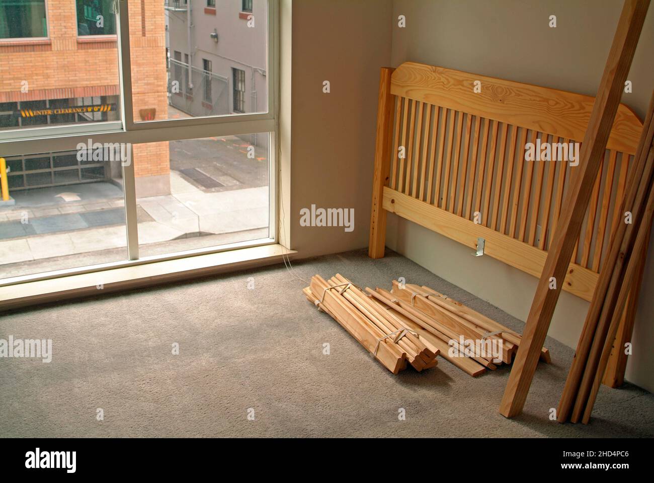 Dissasembled bed in empty urban apartment. Stock Photo