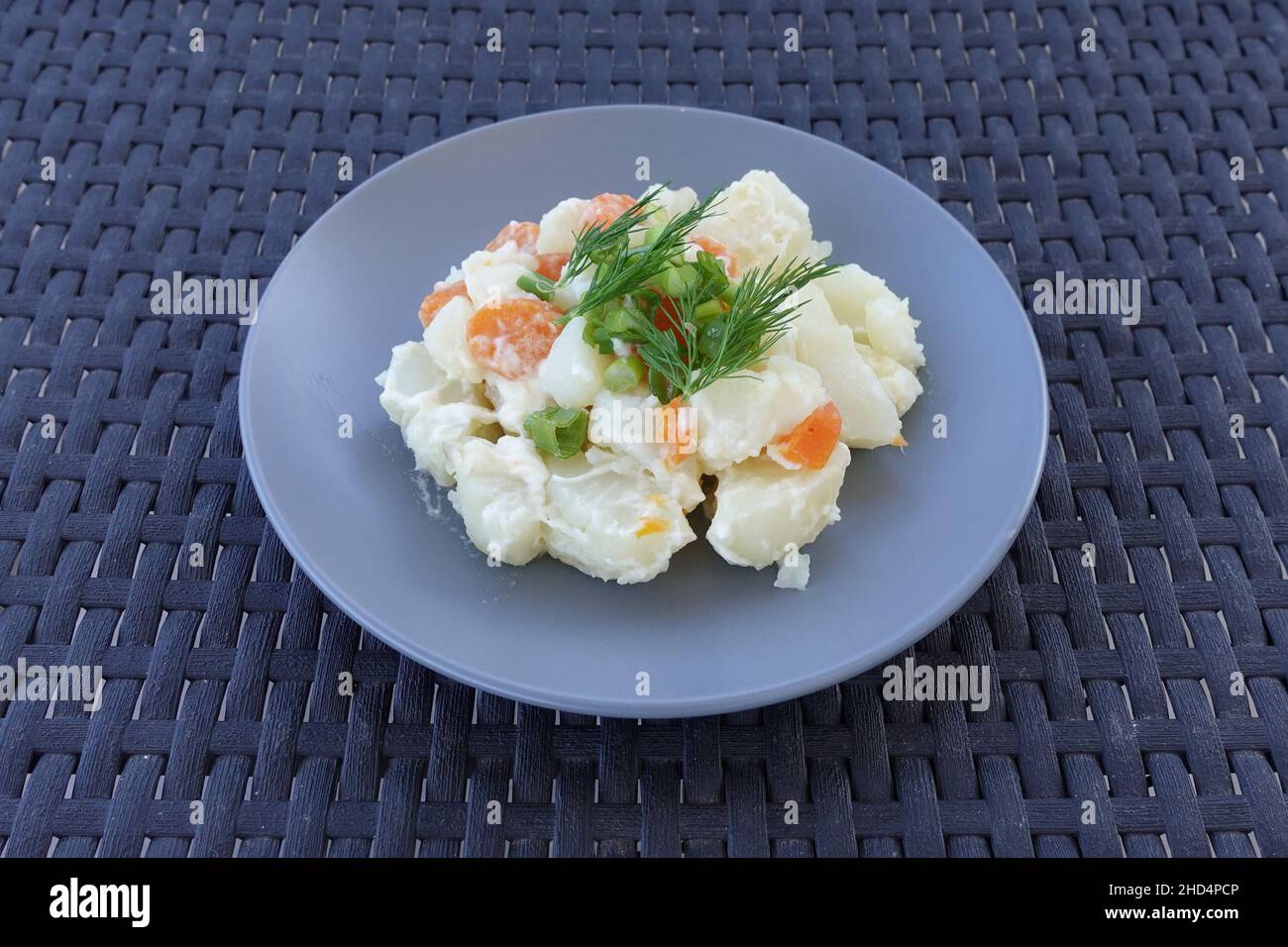 Potato salad with mayonnaise carrots green onions and dill. Appetizer food. Stock Photo