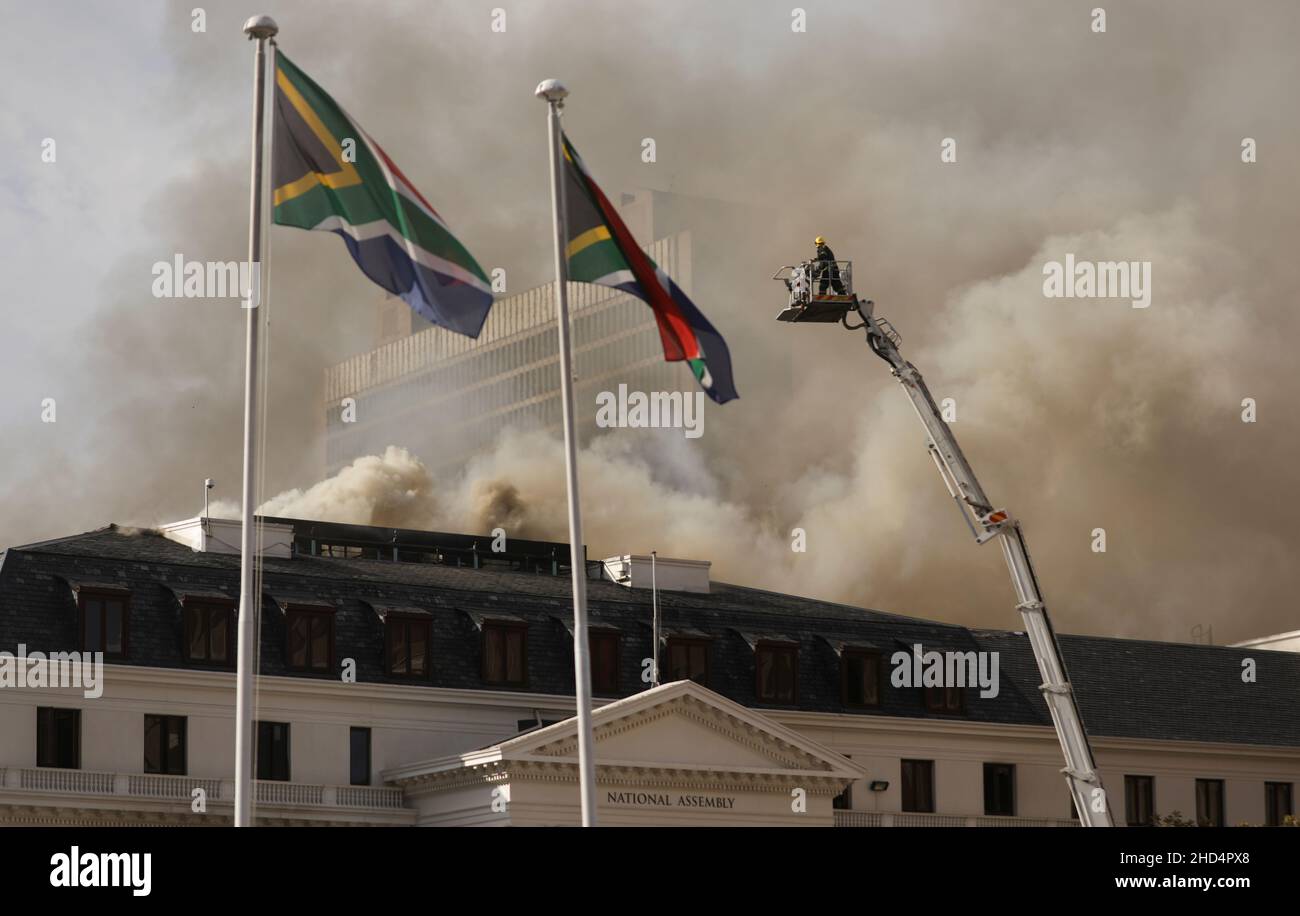 Firemen work at the parliament where a fire broke out in Cape Town, South Africa, January 3, 2022. REUTERS/Mike Hutchings Stock Photo