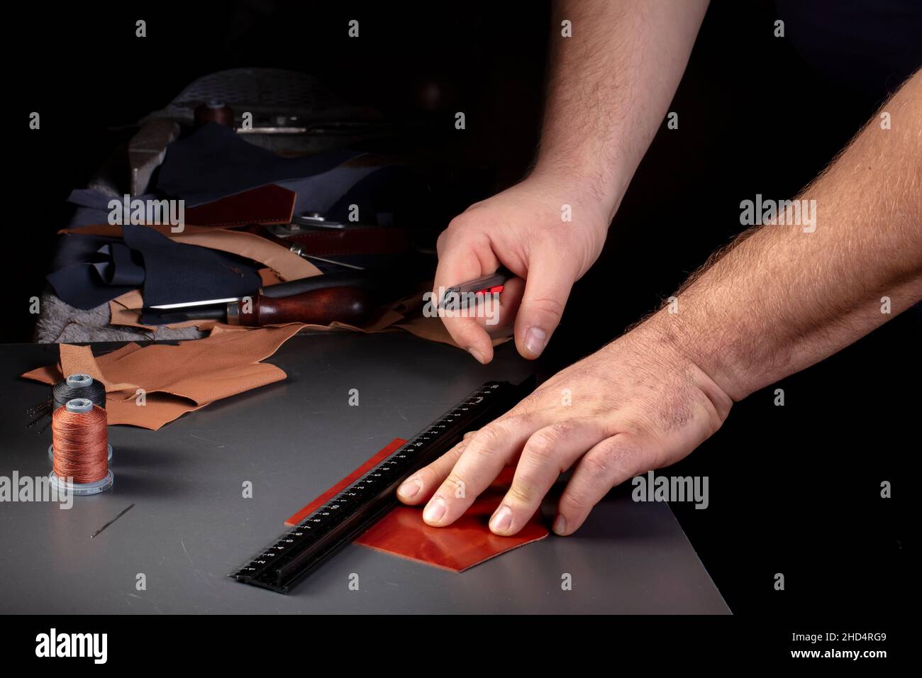 The process of making leather goods. The hands of the master work with
