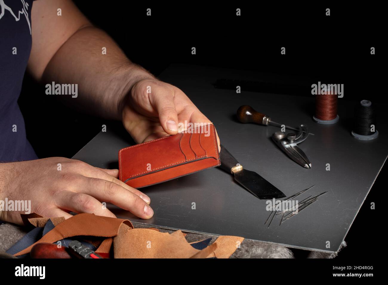 The process of making leather goods. The hands of the master work with