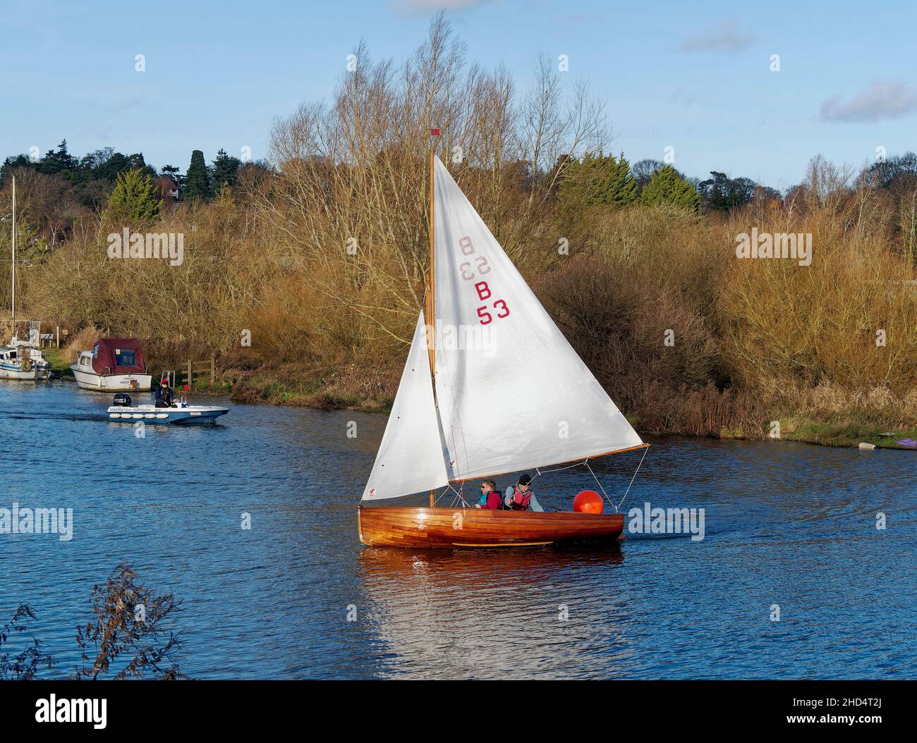 Norfolk 14 foot One Design sailing dinghy, a classic sailboat from1931 with a mahogany clinker built hull and gunter rig seen on River Yare Norwich. Stock Photo