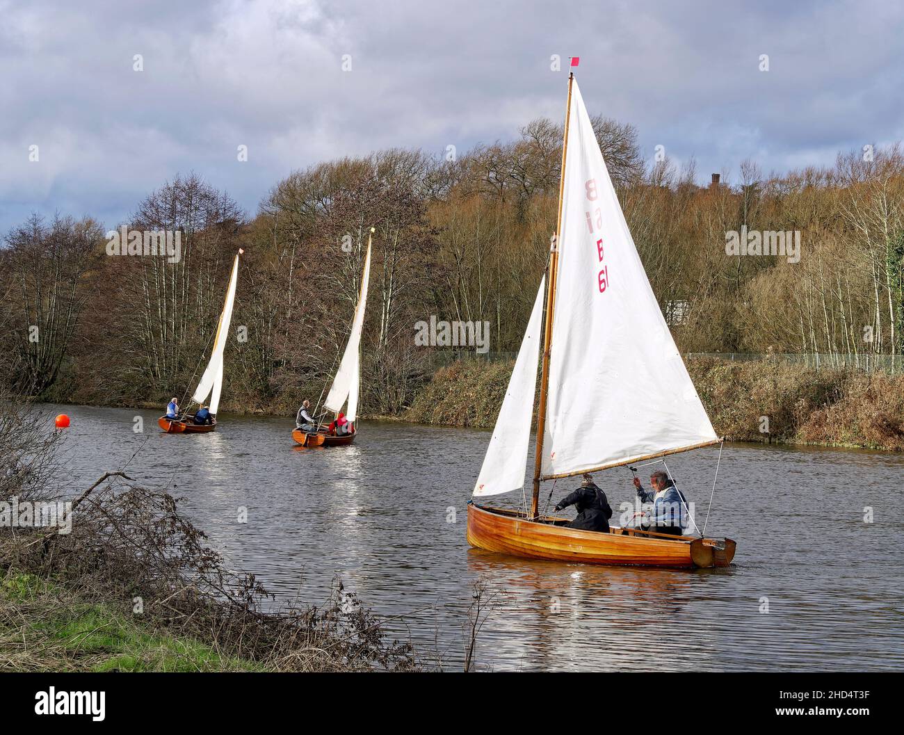 Norfolk 14 foot One Design sailing dinghy, a classic sailboat from1931 with a mahogany clinker built hull and gunter rig seen on River Yare Norwich. Stock Photo