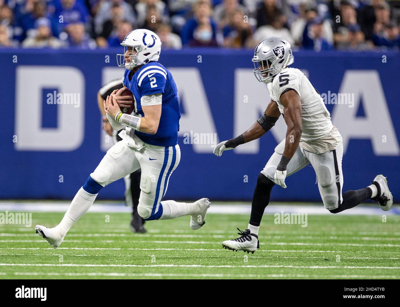 Indianapolis, Indiana, USA. 02nd Jan, 2022. Indianapolis Colts quarterback  Carson Wentz (2) runs with the ball as Las Vegas Raiders linebacker Divine  Deablo (5) pursues during NFL football game action between the