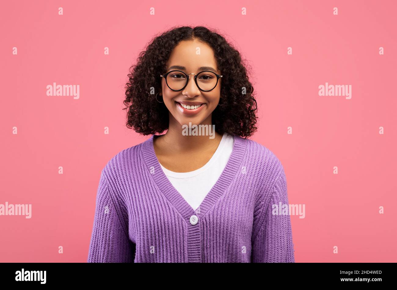 Happy young African American woman with beautiful smile and curly hair ...