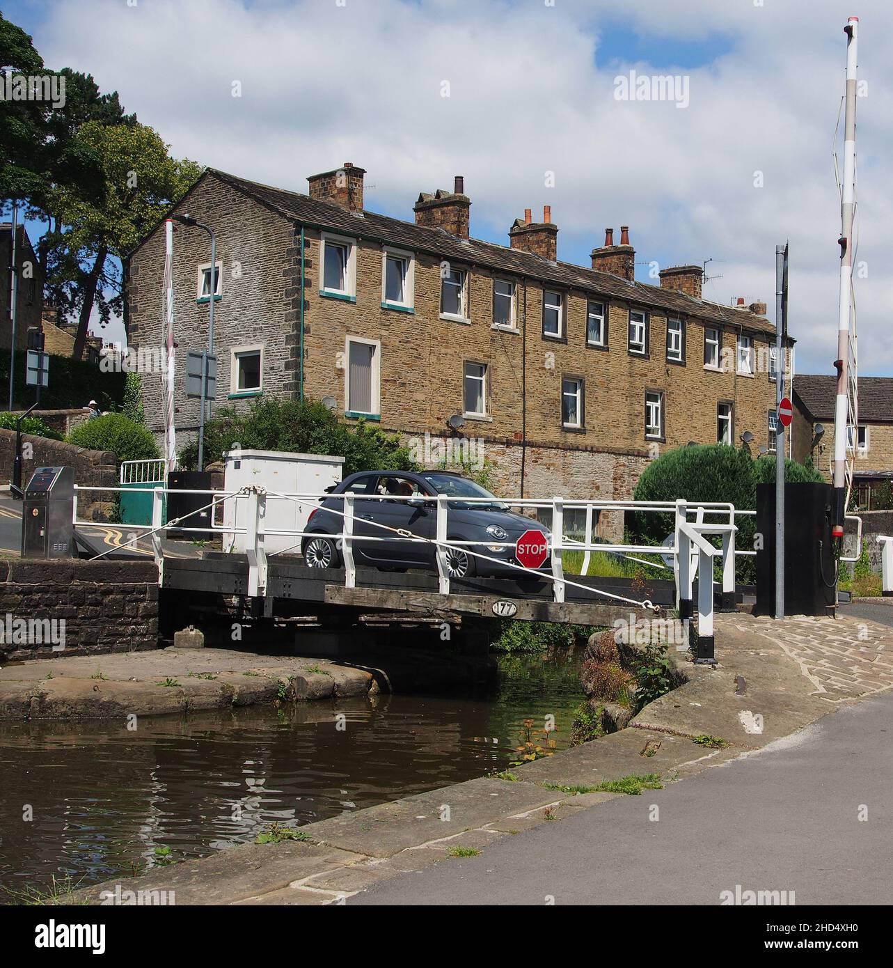 Car crossing the swing bridge on the Thanet Canal or Springs Branch of the Leeds and Liverpool canal which runs from Skipton to Skipton castle. Stock Photo