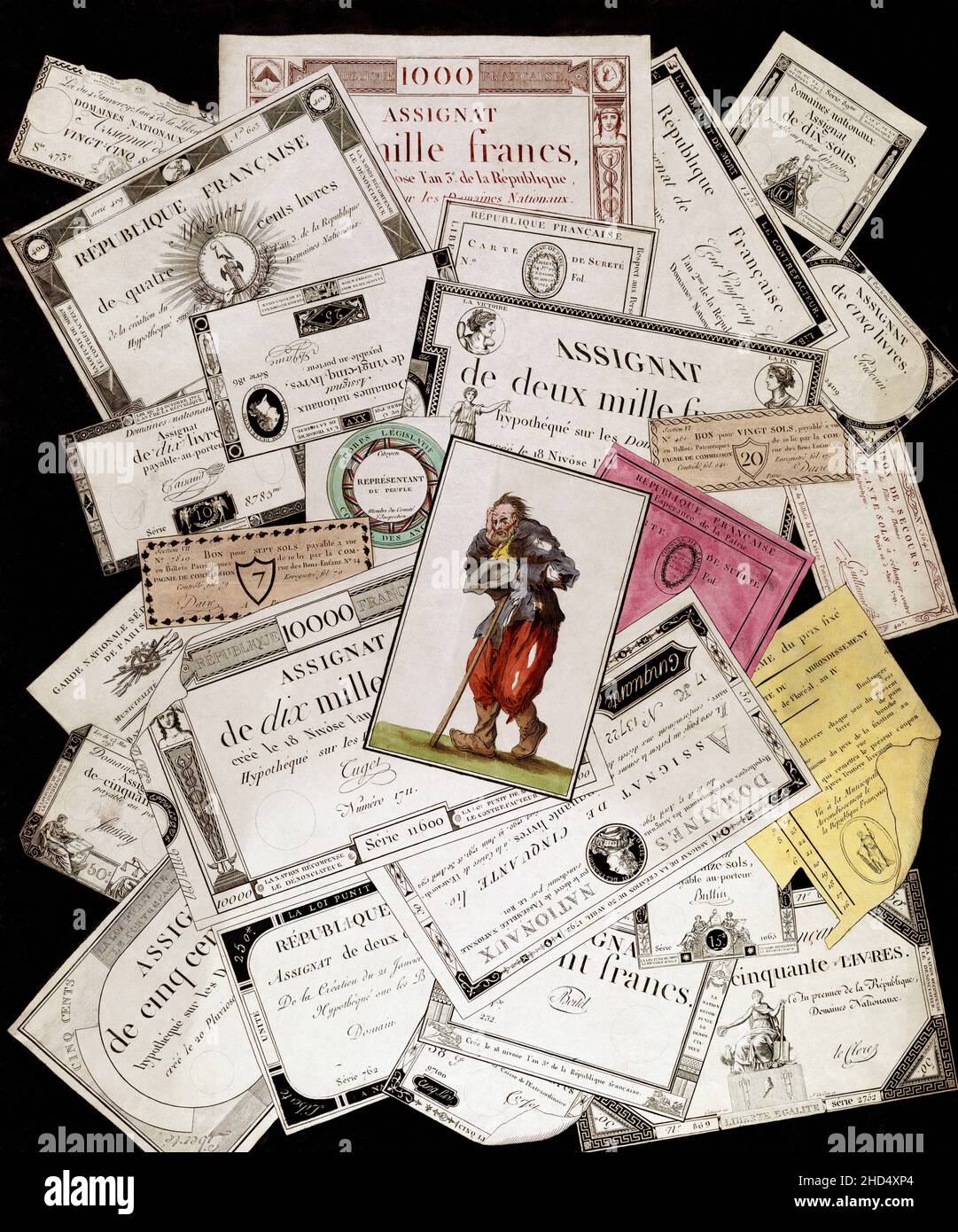 Assignats, paper bills issued as currency from 1789 to 1796 during the French Revolution.  They were initially backed by the value of expropriated properties, but as those properties were sold and still more assignats were issued the system succumbed to inflation.  The Tarot card of The Fool, or The Beggar, on top of the assignats sums up the poor man's lot during the latter years of the assignats hyperinflation. Stock Photo