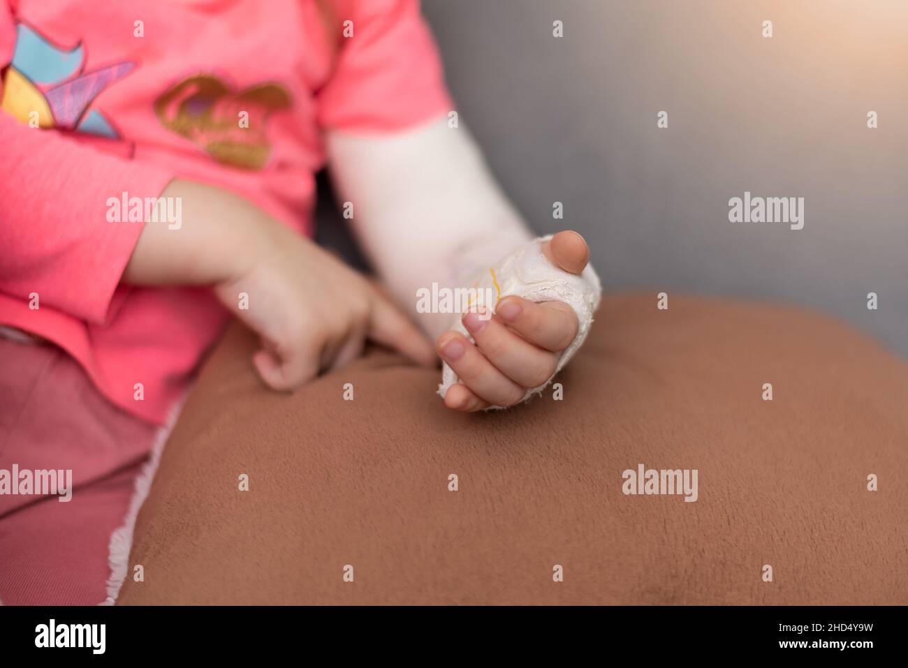 Girl's broken left arm has drawn a cute image on her arm on the plaster