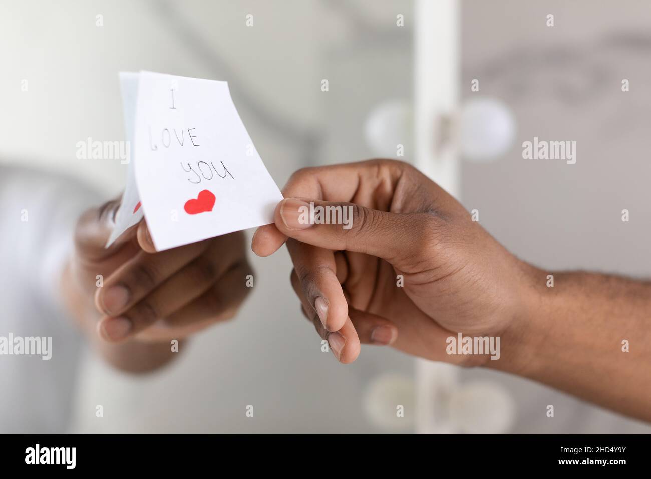 Male Hand Putting Sticky Note With I Love You Text On Mirror Stock Photo