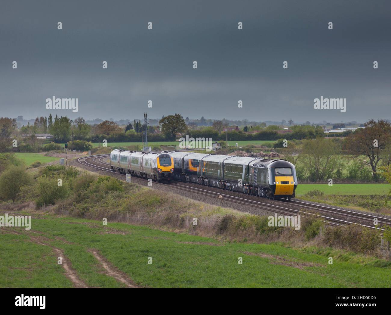 Crosscountry Trains Voyager and Great Western railway castle high speed train passing in the Gloucestershire countryside with copy space Stock Photo
