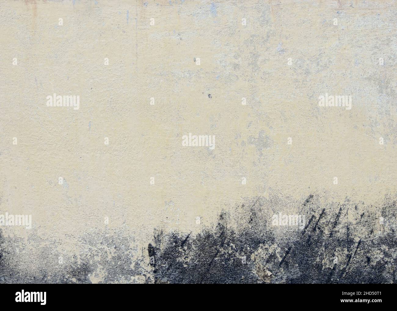 Old textured white painted wall background with black stains Stock Photo