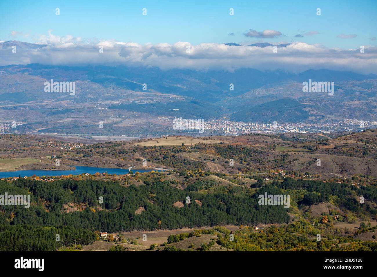 Beautiful view of a big landscape with trees and a small blue lake under a cloudy sky in Bulgaria Stock Photo