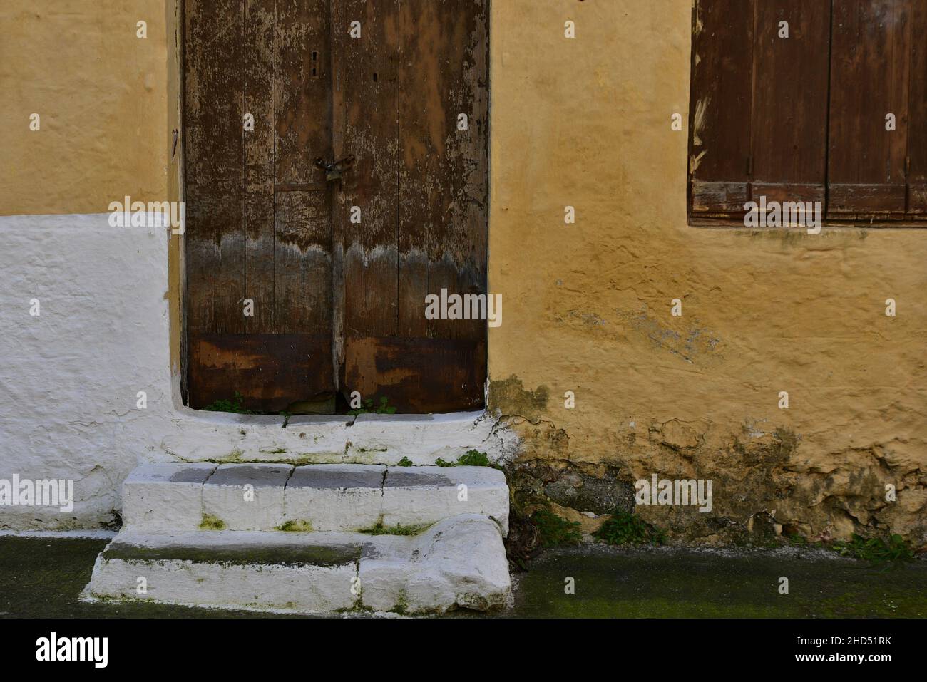 Old traditional rural house facade with an antique wooden door and ...