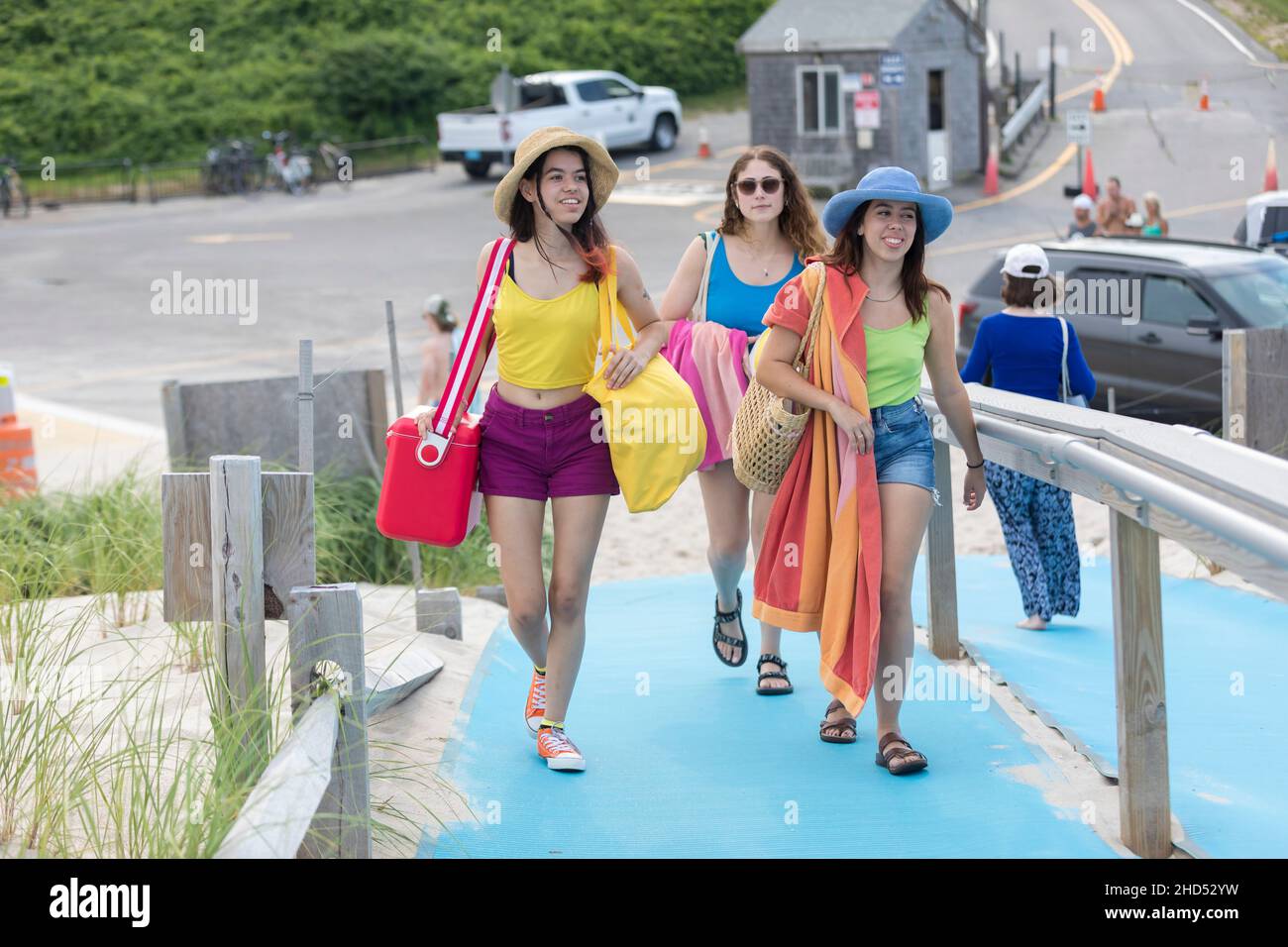 Three college-aged girlfriends walking to the beach Stock Photo