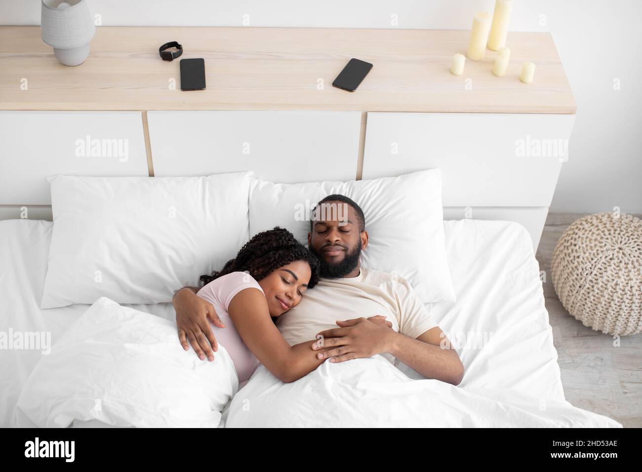 Calm Millennial African American Female And Male Sleeping At Night Hugging On Bed In Bedroom