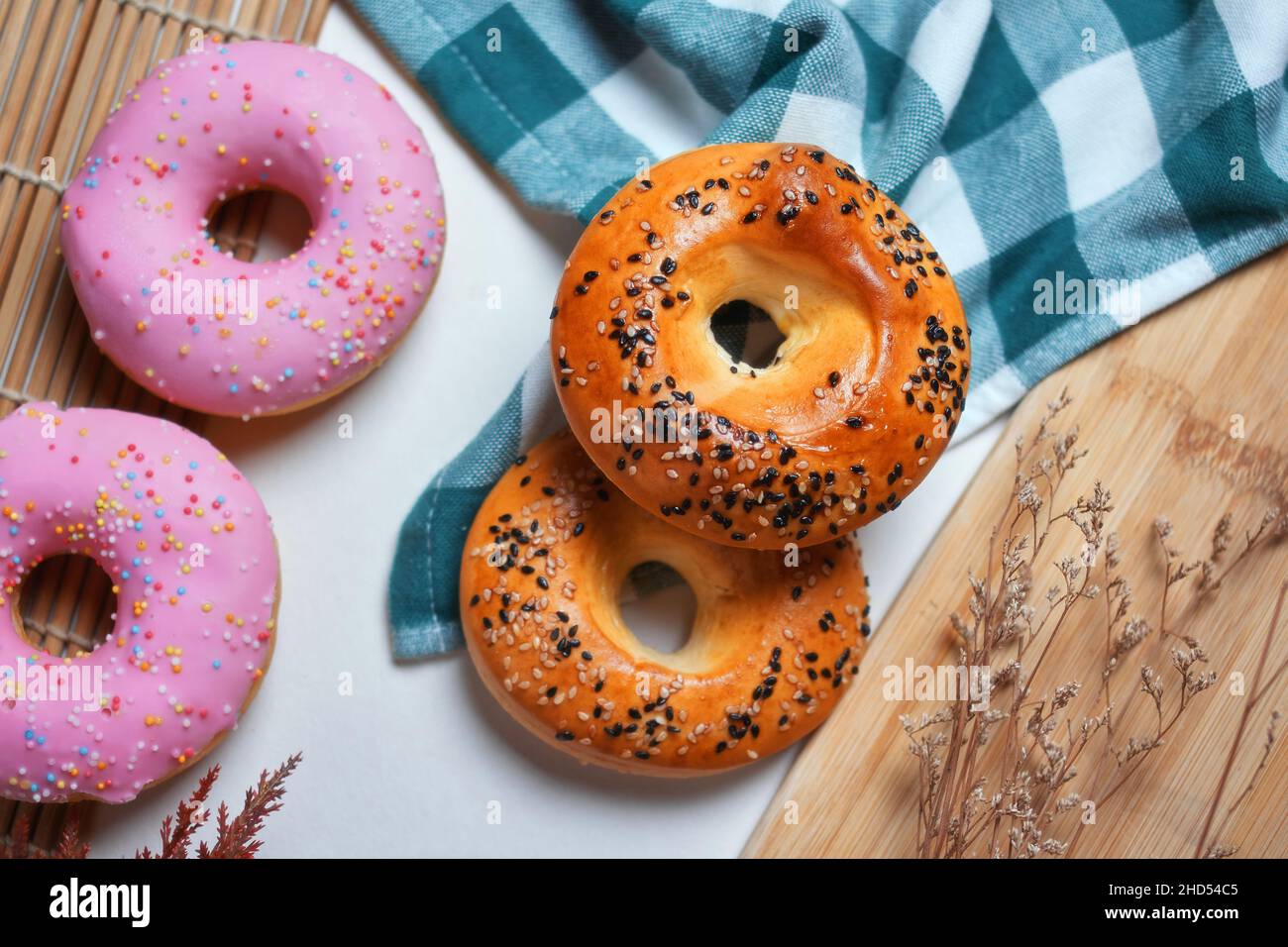Close-up view of sesame seed and glazed donuts on the table Stock Photo
