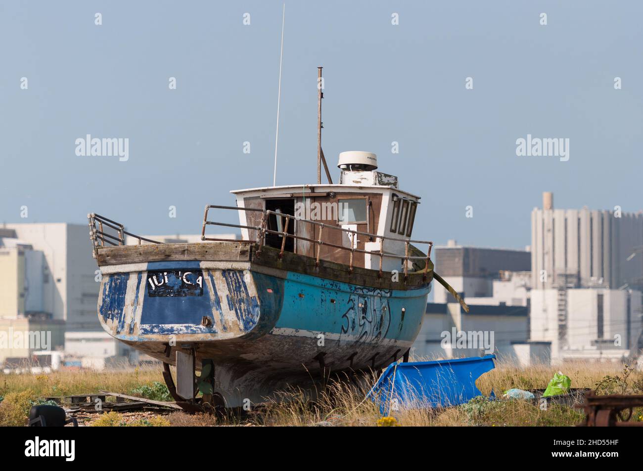 Fishing boat on the shingle beach above high water. Dungeness, Kent, England, UK Stock Photo
