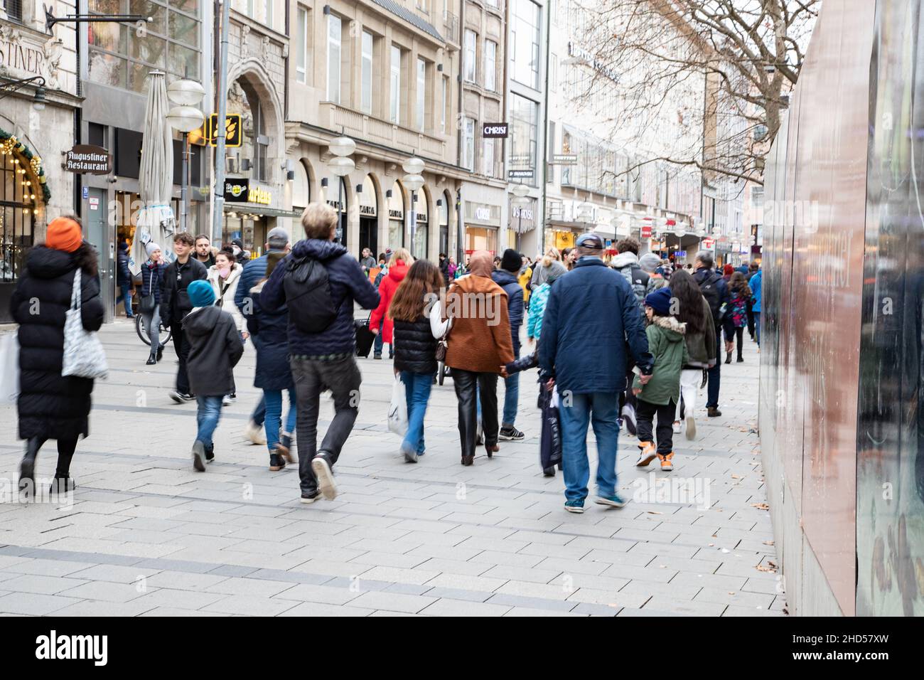 People go shopping in Munich, Germany on January 3rd, 2022. If one wants to go  shopping clothes one doesn't have to be vaccinated anymore, but for other  shops in the pedestrian zone