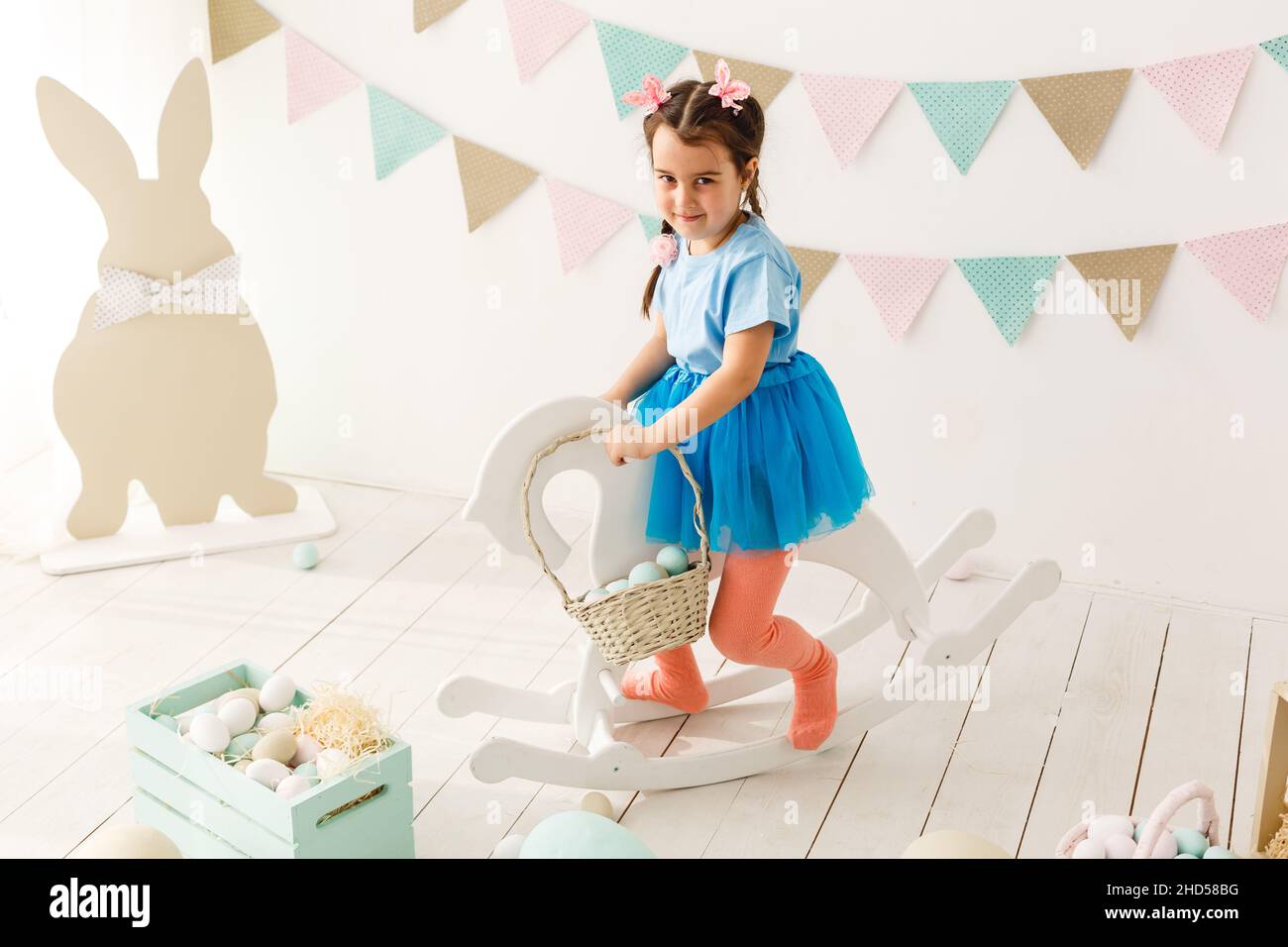 Cute little girl with bunny ears and basket of Easter eggs Stock Photo ...