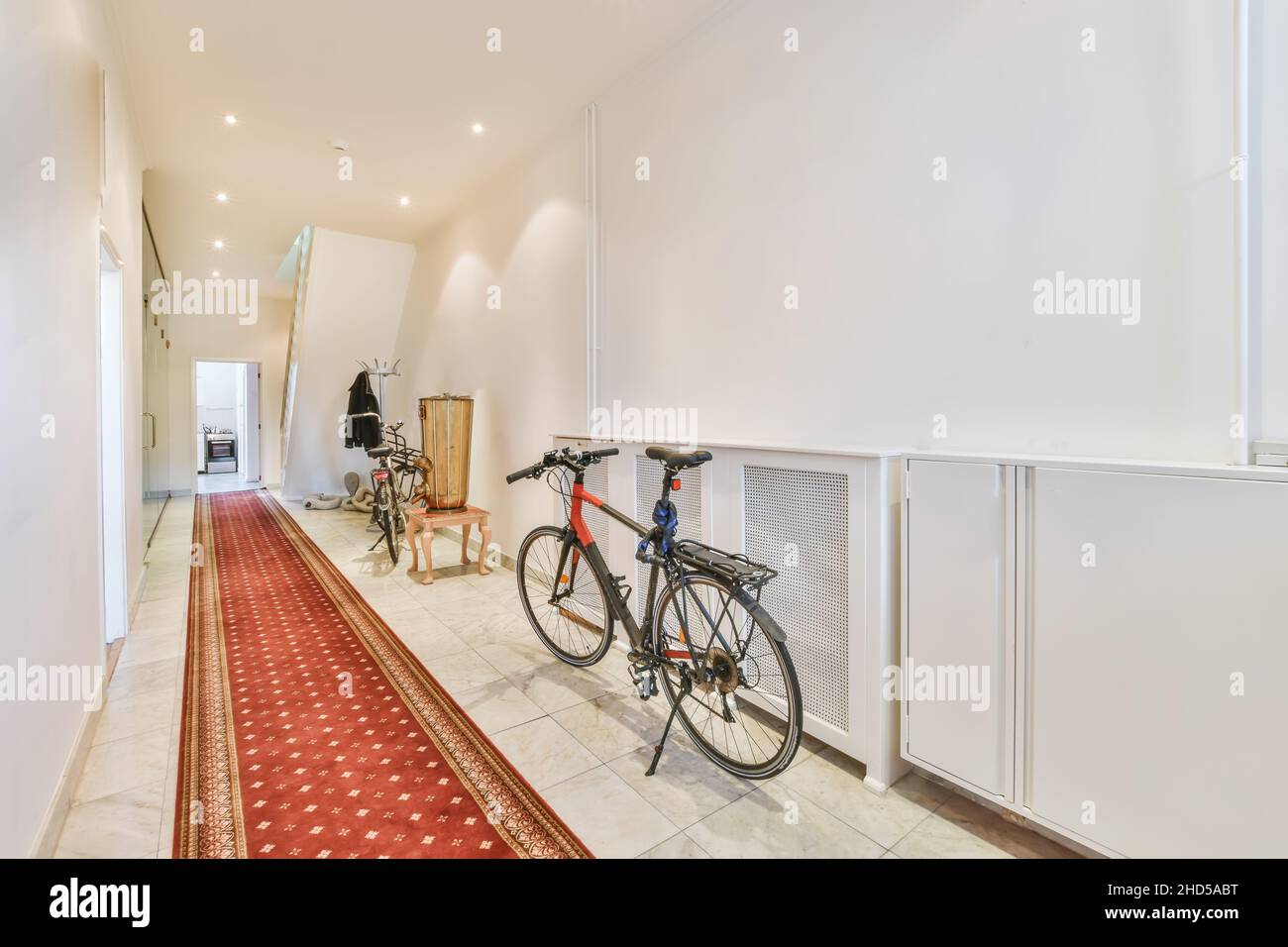 Spacious and long corridor with white walls and stunning tiles Stock