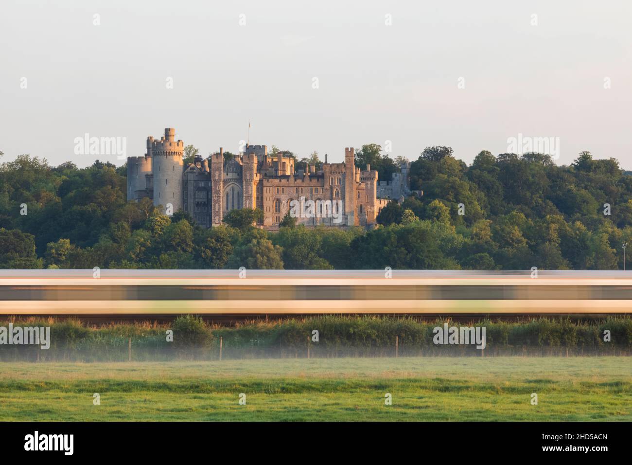 England, West Sussex, Arundel, Train Passing by Medieval Arundel Castle and Early Morning Mist Stock Photo