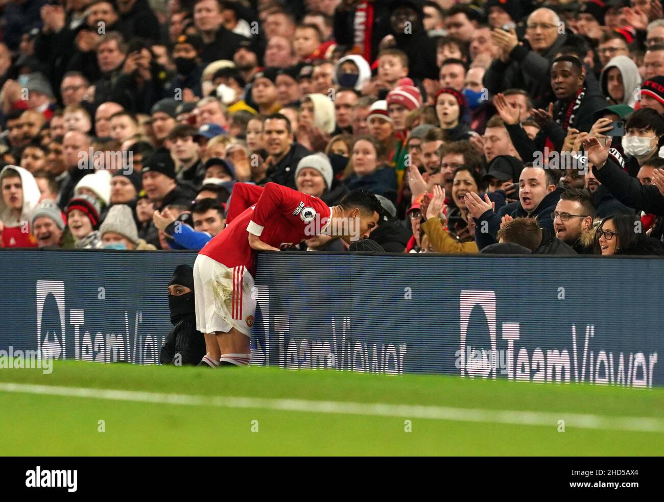 Manchester United's Cristiano Ronaldo narrowly avoids falling over the advert board during the Premier League match at Old Trafford, Manchester. Picture date: Monday January 3, 2022. Stock Photo