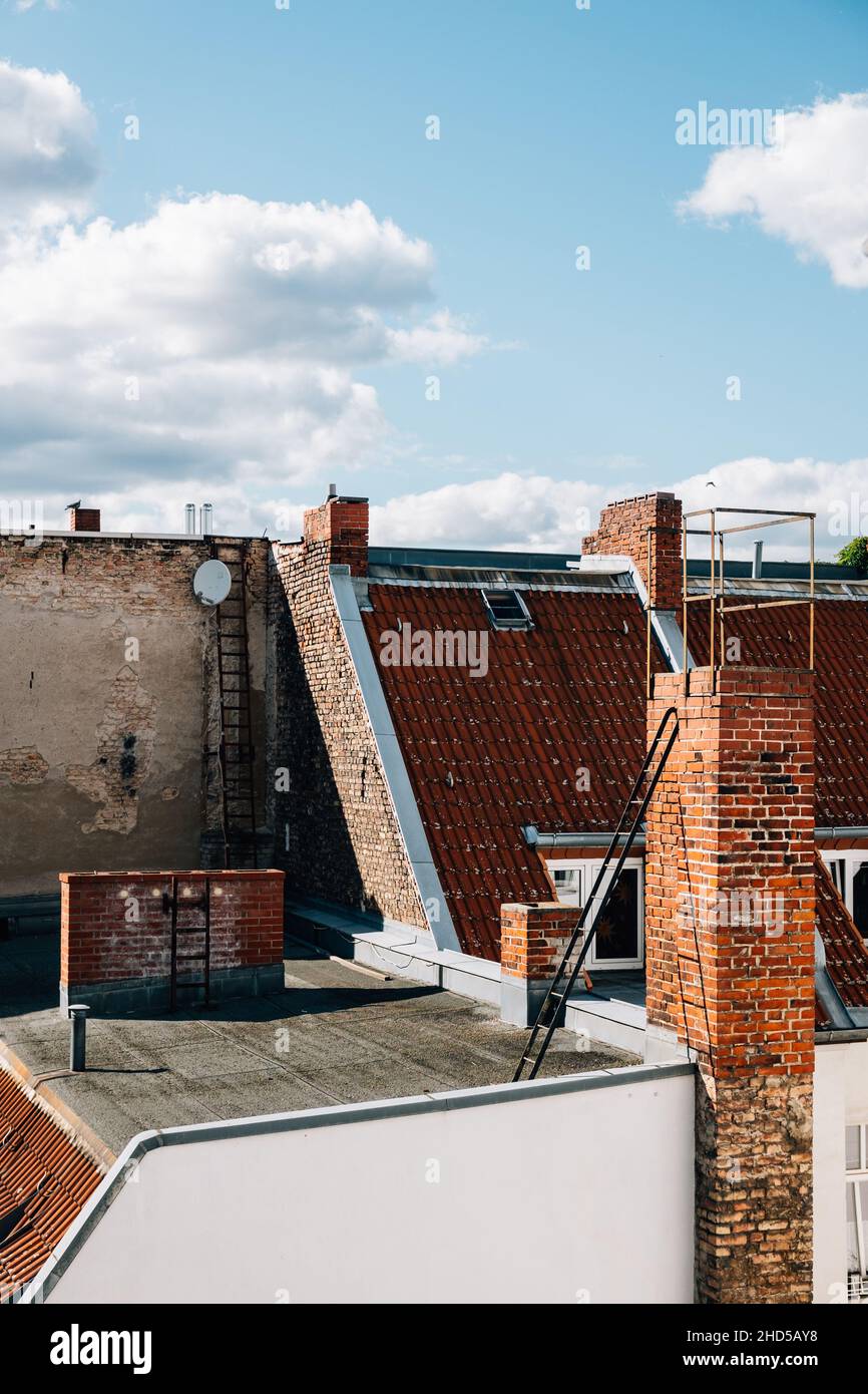 Vertical shot of brick buildings under the cloudy sky Stock Photo - Alamy