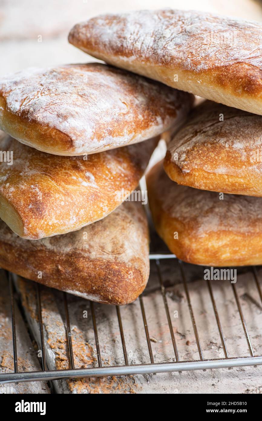 Batch of ciabatta bread on a cooling rack. Close up. Stock Photo