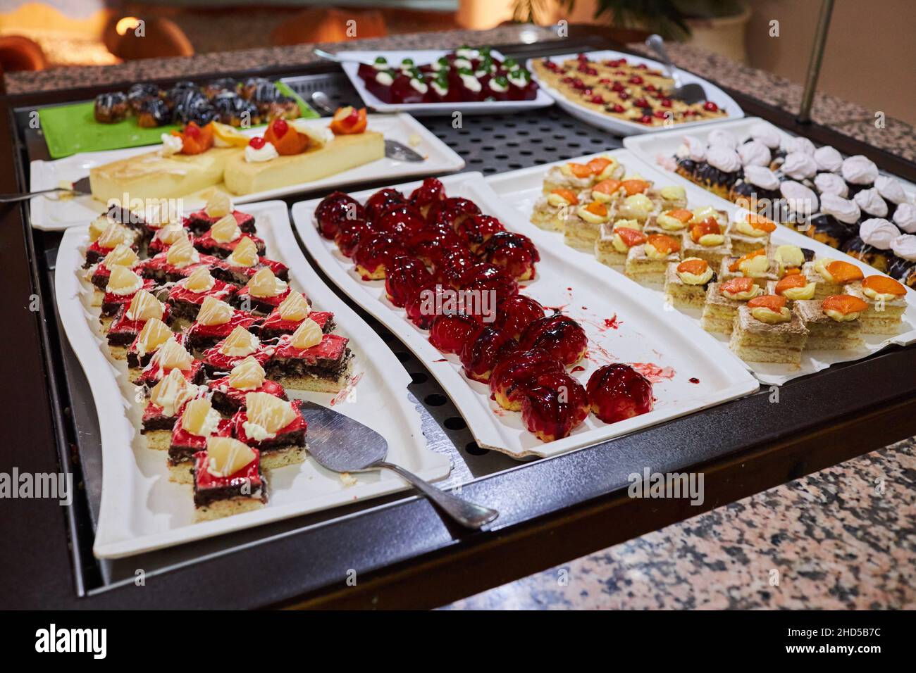 Various desserts in candy bar food buffet during hotel brunch. Self service in hotel restaurant Stock Photo