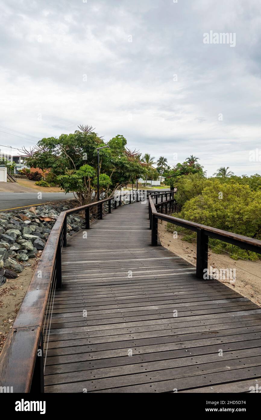 a timber walking path along the ocean shoreline in a tourist township ...