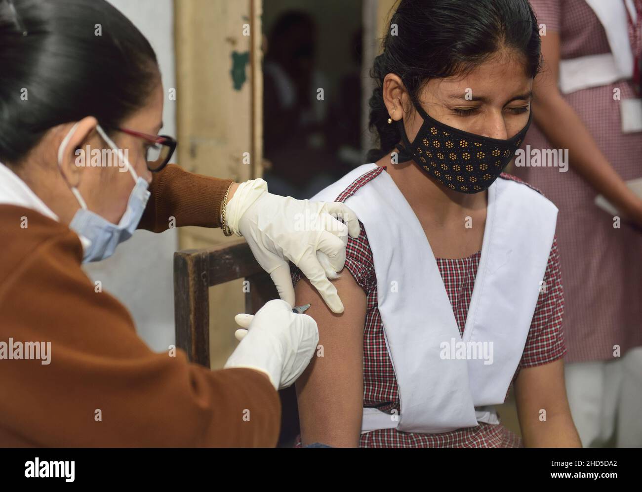 Kolkata, India. 1st Jan, 2014. A health worker administers a dose of Covaxin vaccine to a student at Uccha Balika Vidyalaya (Barisha) school in Kolkata.In India Covid vaccination for 15 to 18 year age group starts today. Nearly 2.7 million teenagers have registered for their jabs even as a country witnessing a sharp surge of Covid-19 cases fueled by the new Omicron variant of coronavirus. (Credit Image: © Sumit Sanyal/SOPA Images via ZUMA Press Wire) Stock Photo