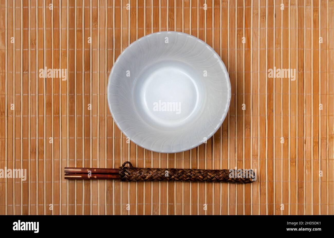 asian style bowl and chopstick on bamboo background. Stock Photo