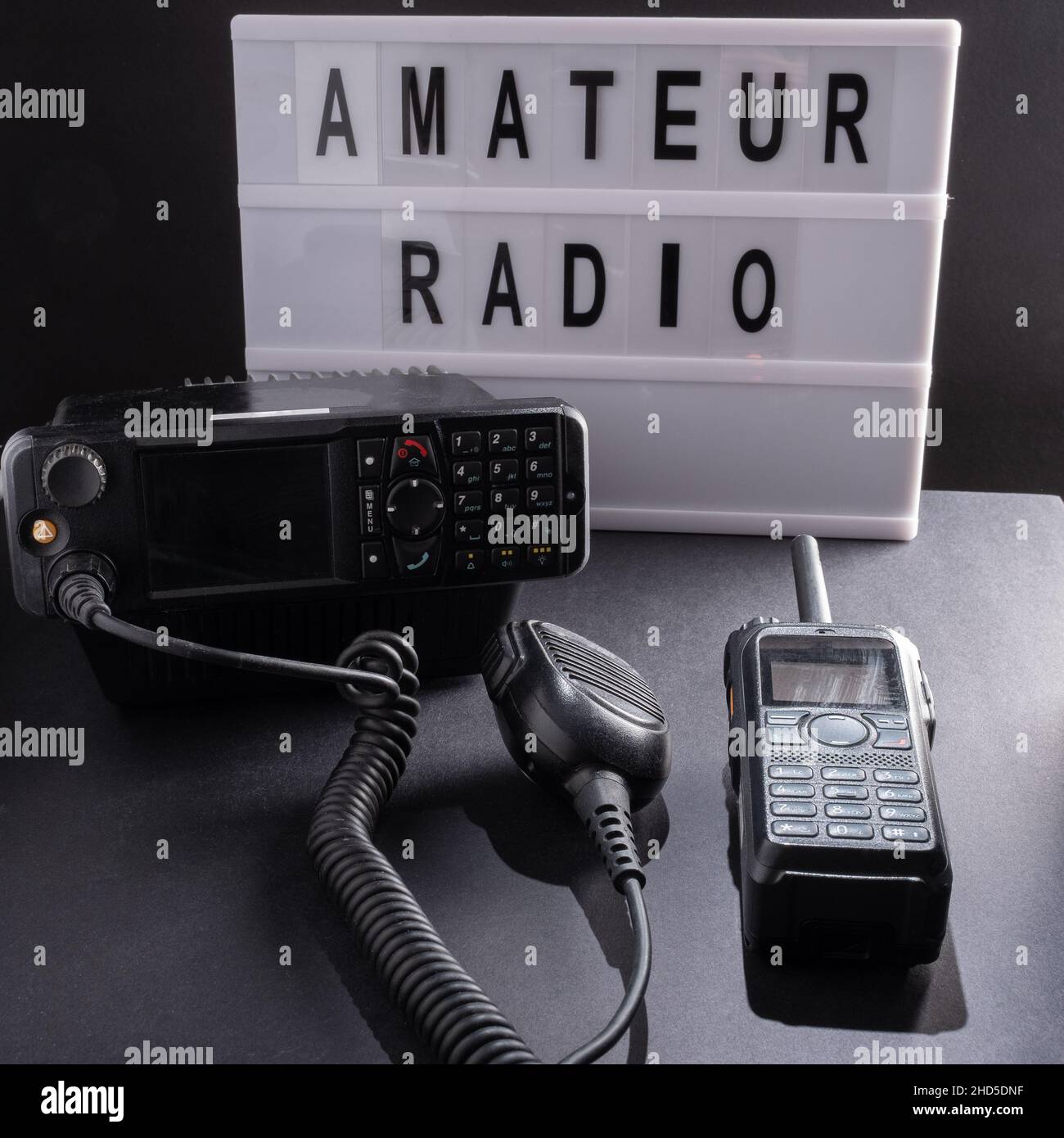 Helsinki / Finland - JANUARY 3, 2022: Closeup of pair of mobile two-way radios for Amateur radio operators against a dark background. Stock Photo