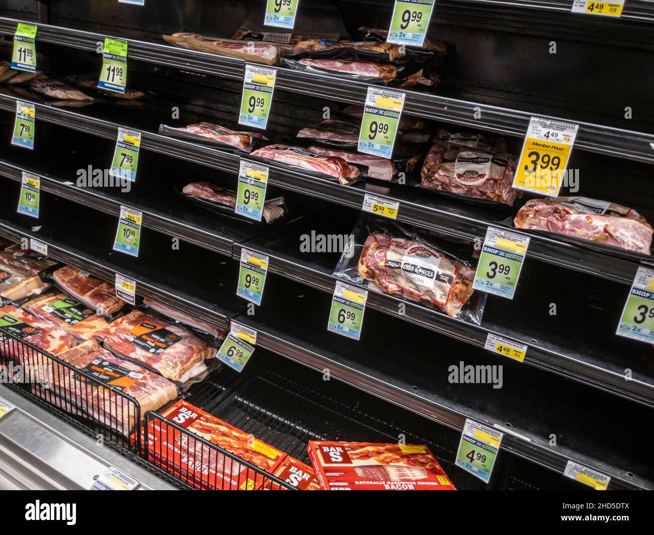 Kirkland, WA USA - circa January 2022: Angled view of food shortage in the refrigerated meats aisle in a Safeway grocery store during heavy snow storm Stock Photo