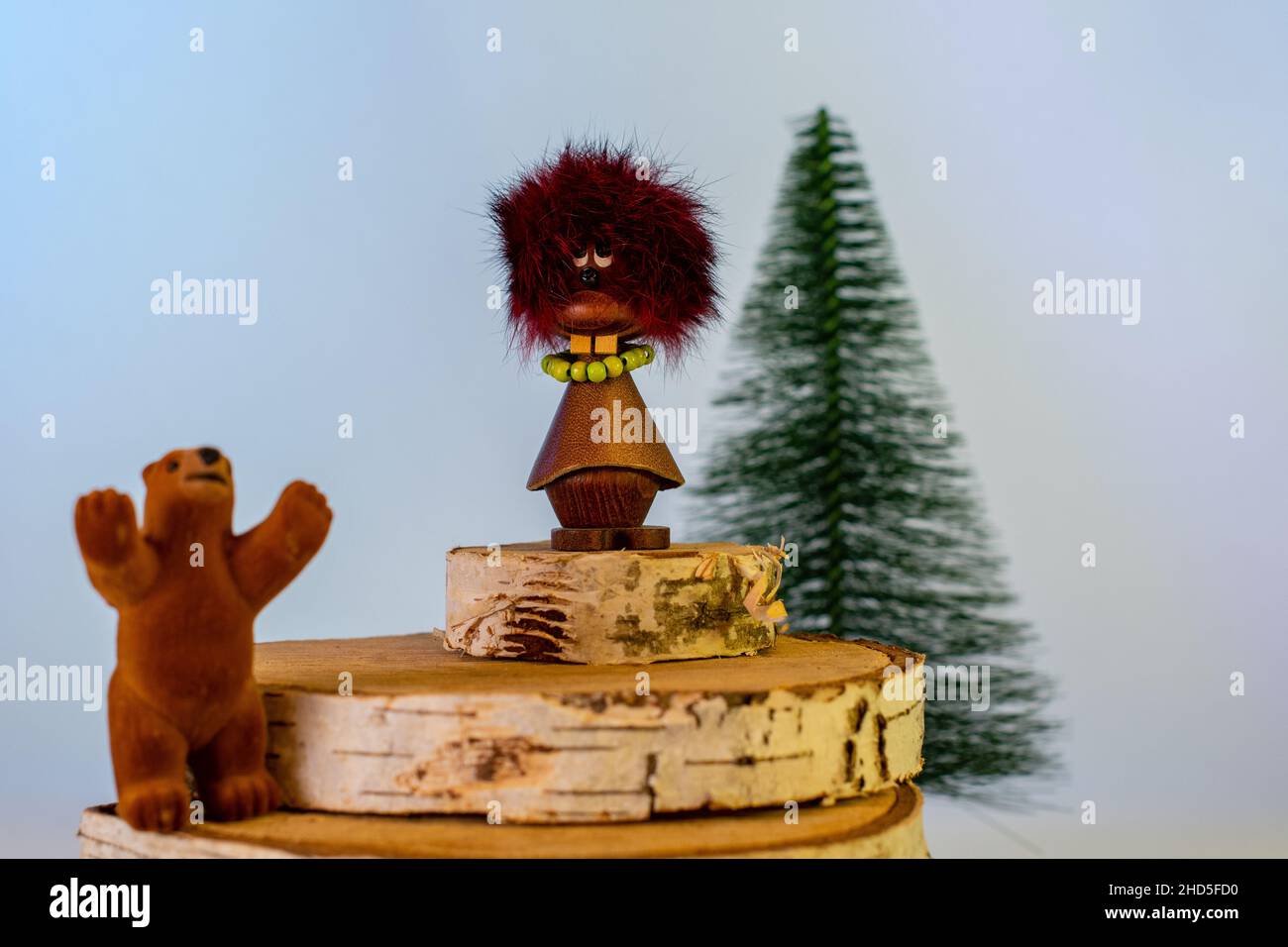 Manikin toy with bear and fir tree Stock Photo