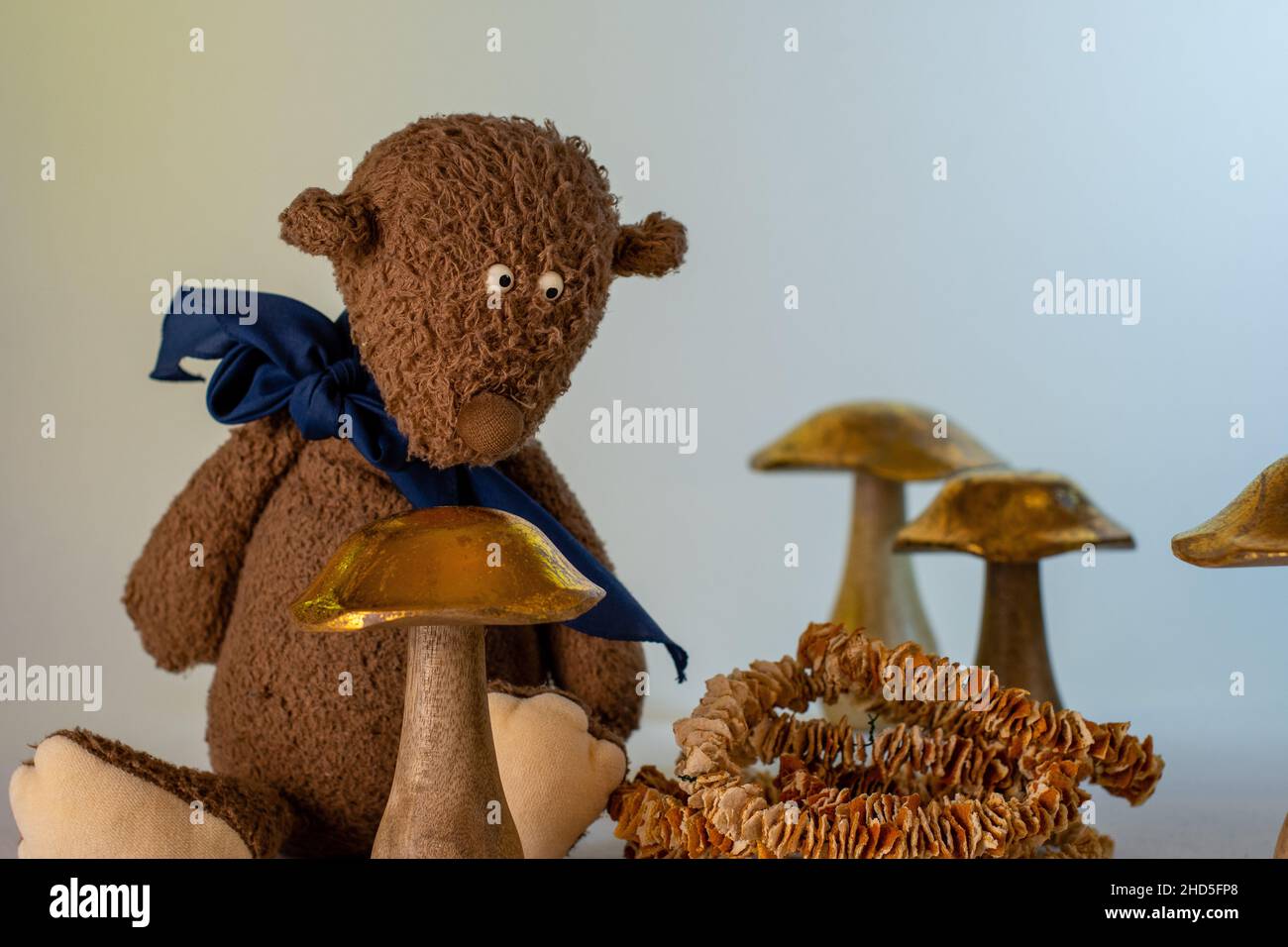 Teddy Teddybear with golden wooden mushrooms Stock Photo