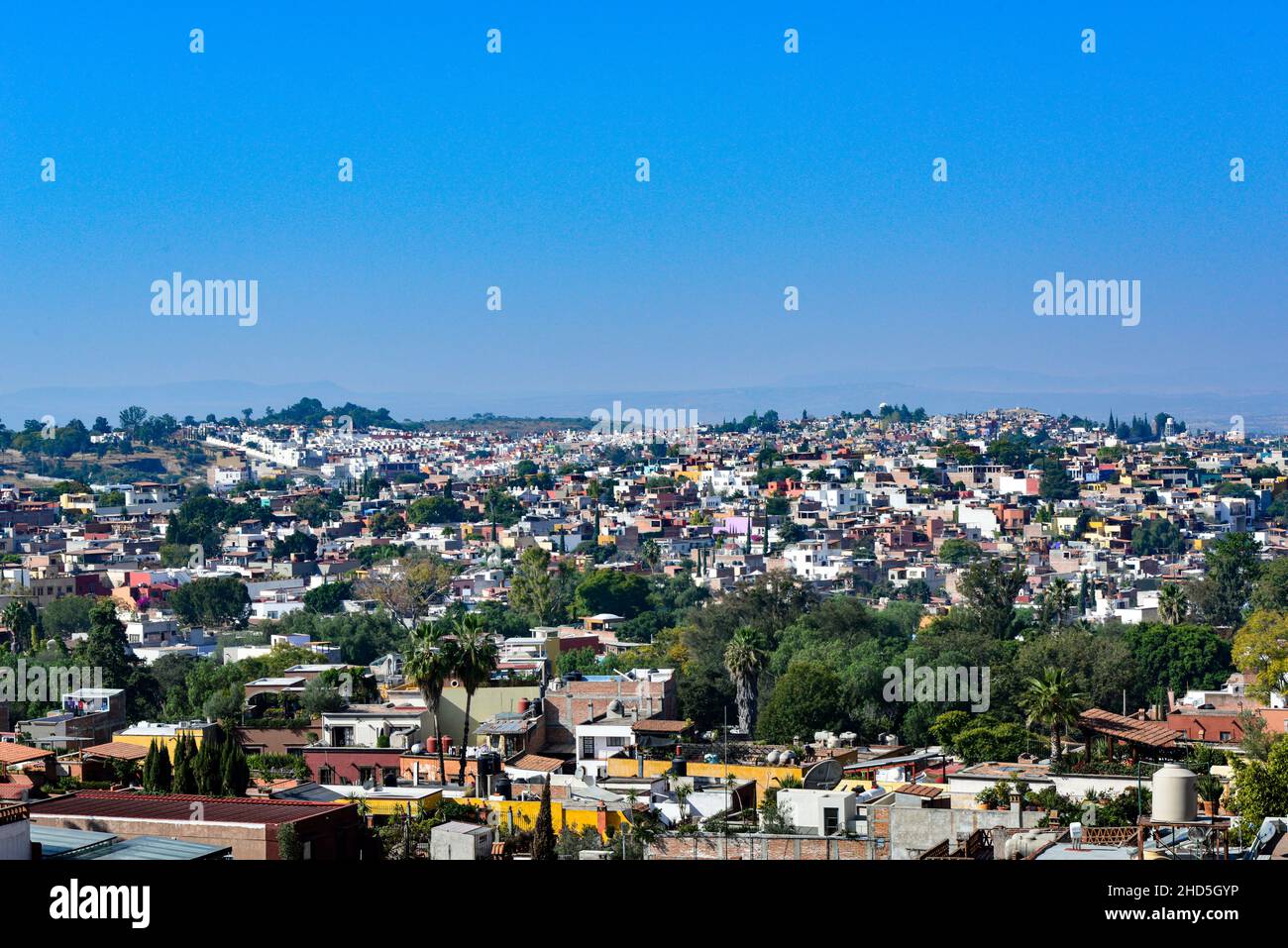 View from San Miguel de Allende, Mexico, overlooking a neighborhood with mountains in the