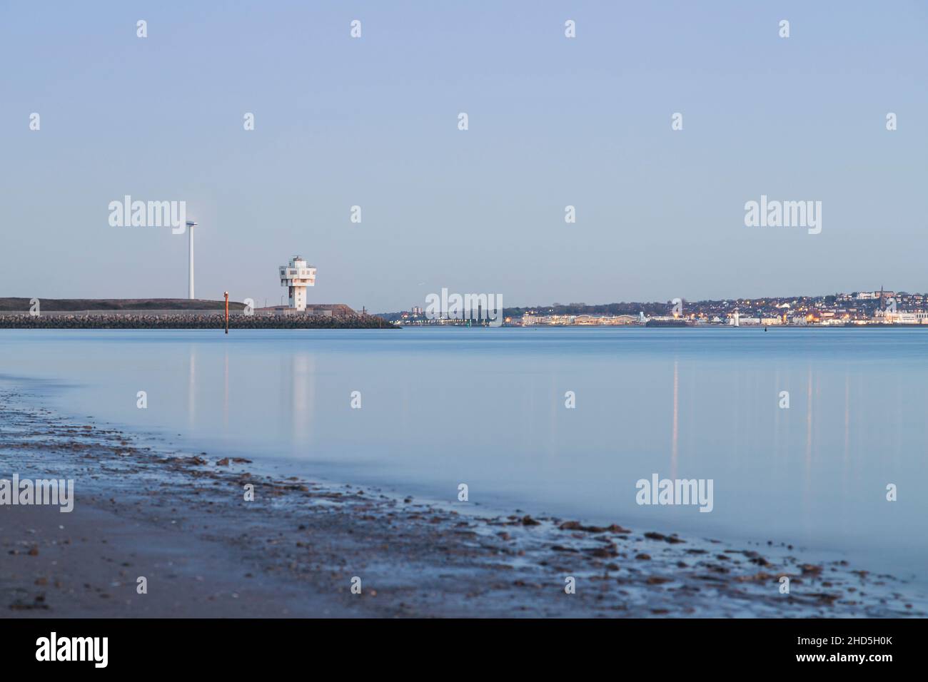 High tide on Crosby beach showing the lighthouse on the corner of