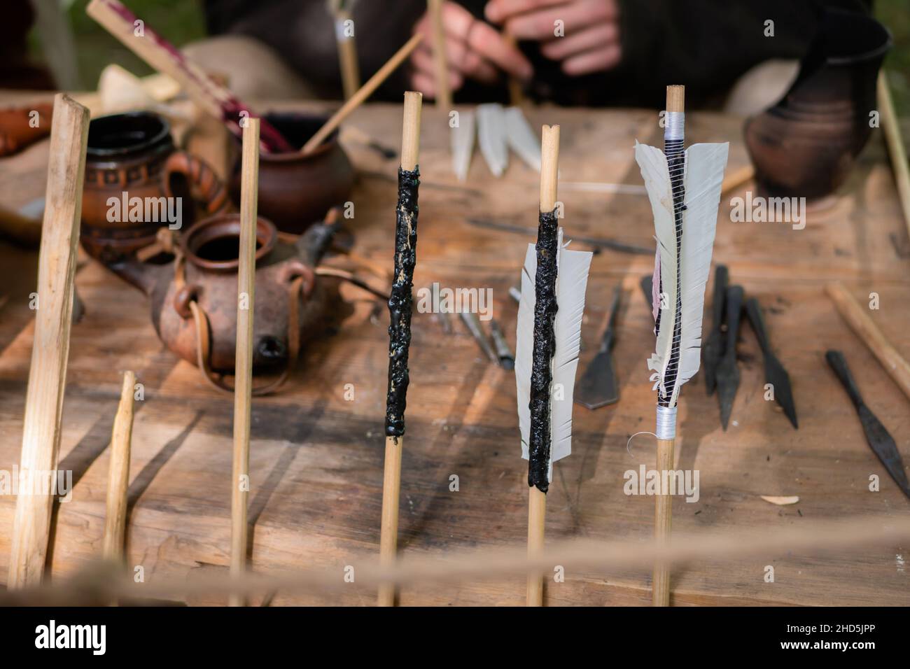 Wooden archery arrows with fletching at medieval outdoor festival - close up Stock Photo