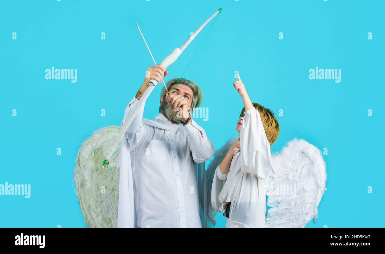 Valentines Day. Father and little son angels with bow and arrow. Cupid boy and dad with white wings Stock Photo