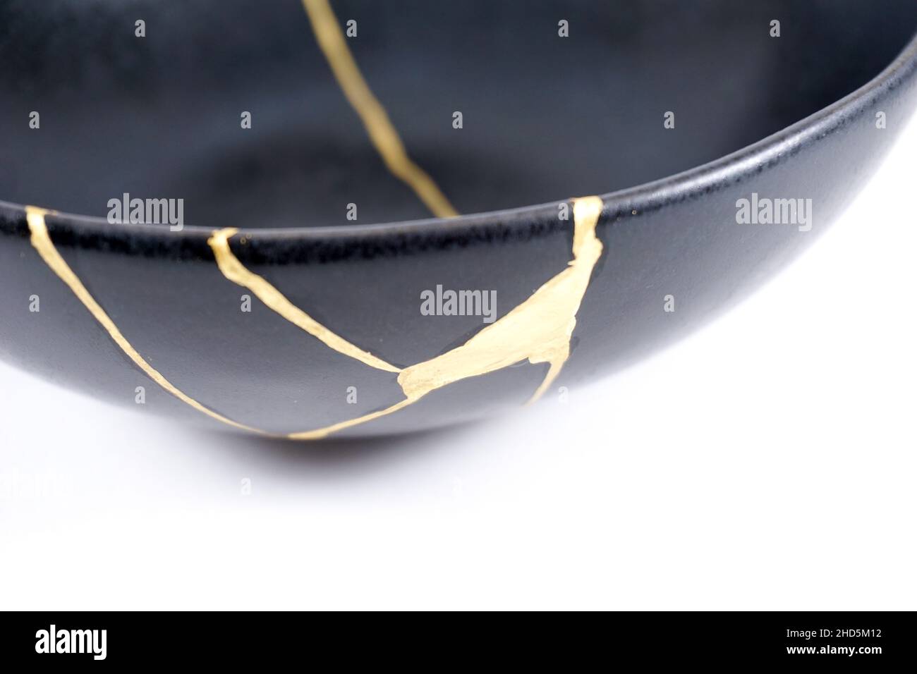 kintsugi gold cracks restoration, Japanese black bowl fixed with the ...