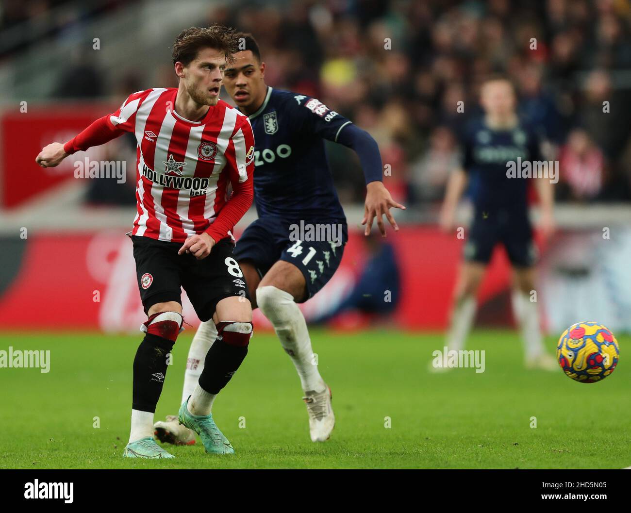 BRENTFORD, ENGLAND - JANUARY 02: Mathias Jensen of Brentford is cllosed down by Jacob Ramsey of Aston Villa during the Premier League match between Brentford and Aston Villa at Brentford Community Stadium on January 2, 2022 in Brentford, England. (Photo by Ben Peters/MB Media) Stock Photo